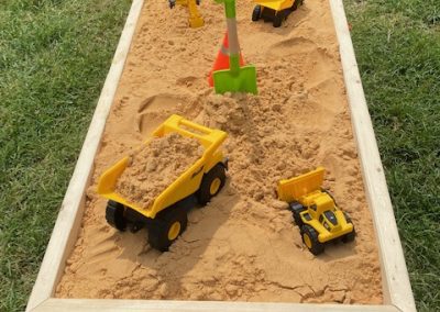 Sandbox with toy construction trucks at the National Night Out in Harford County