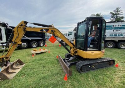 Kid boards a heavy machinery display by Comer Construction at the National Night Out in Harford County