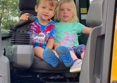 Children boards a heavy machinery display by Comer Construction at the National Night Out in Harford County