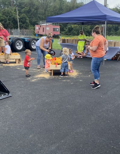 Children enjoying the Comer Construction display with their moms.
