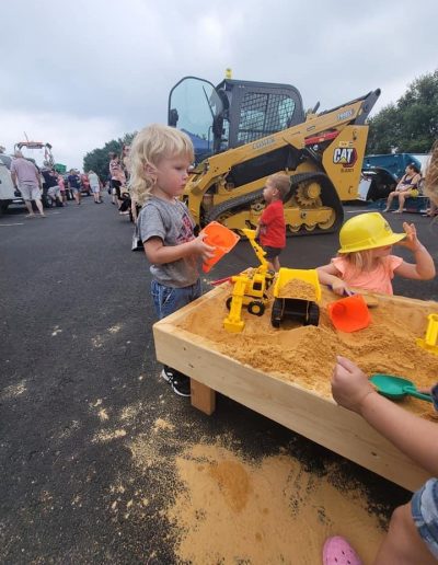 Children play with toys on sandbox