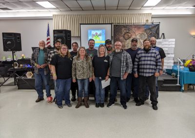 Employees of Comer Construction posing in celebration of the Comer Construction Employee Milestone celebration.