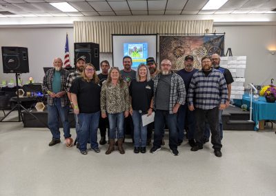 Employees of Comer Construction posing in celebration of the Comer Construction Employee Milestone celebration.