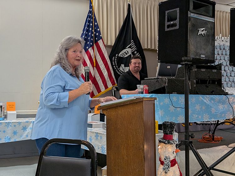 Susie Comer making announcements at the event