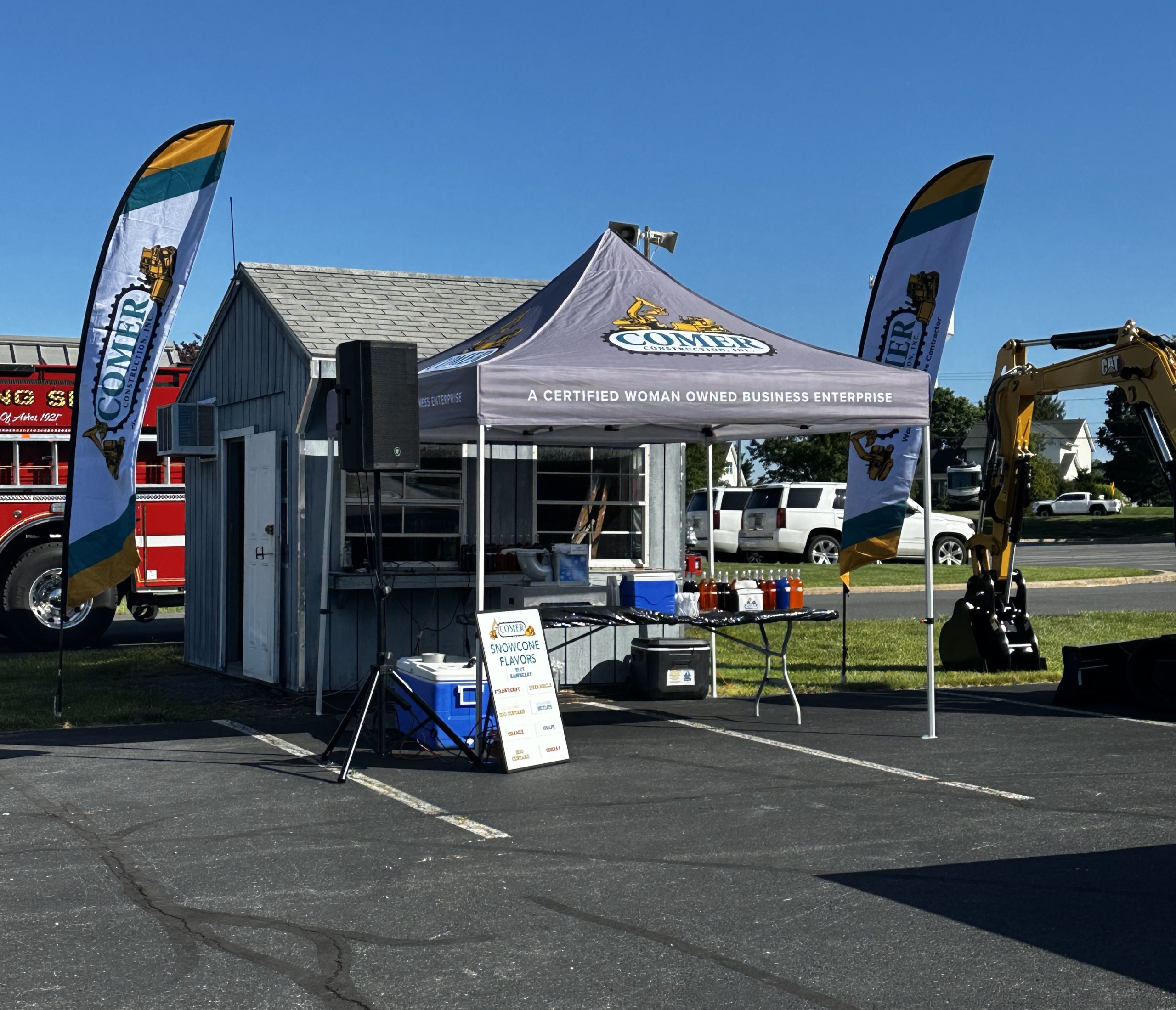 posing outside of Comer Construction booth at touch a truck