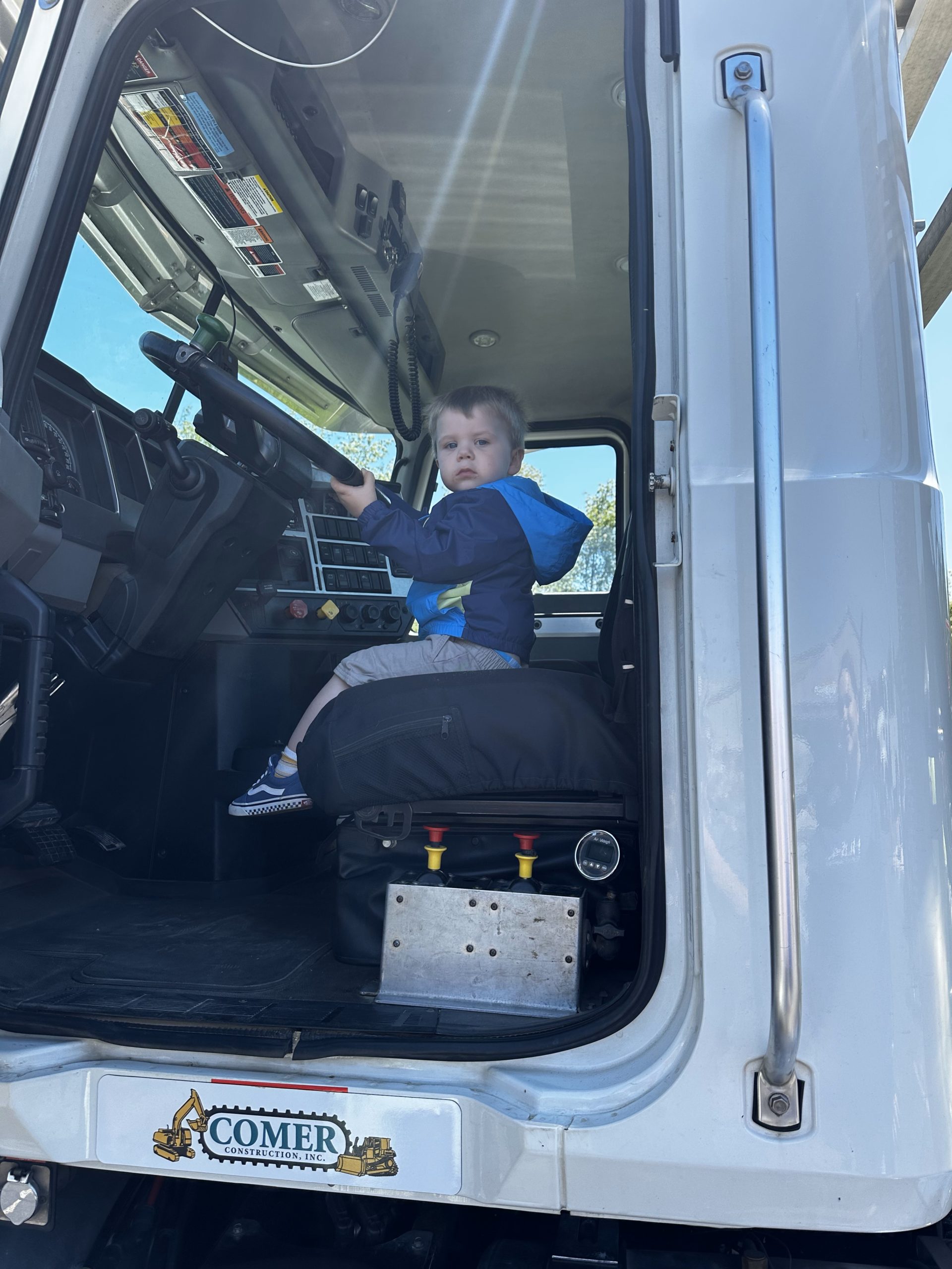 Comer Construction truck and table at touch a truck event