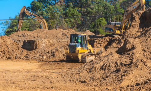 Skid steer moving dirt